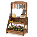 Brown wooden market stand with striped curtain, chalkboards, toy checkout accessories and a staged lower planter