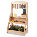 Natural wooden market stand with striped curtain, chalkboards, toy checkout accessories and a staged lower planter