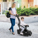 Black Lamborghini push car with parent push handle and footrests in use