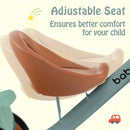 Green tricycle seat showing forward and rear adjustment positions