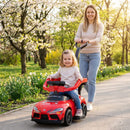 Red toddler toy push car shown with an adult using the parent handle