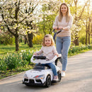 White toddler toy push car shown with an adult using the parent handle