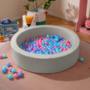 Grey round PU-covered foam ball pit with colourful play balls; room decorations not included