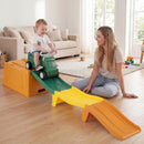 Green ride-on car on the orange, green and yellow track in a supervised indoor scene