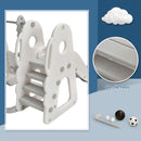 Rear climbing steps of white and grey playset with grooved treads and ball accessories