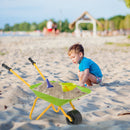 Light Green children’s wheelbarrow staged with sand, a bucket and spade that are not included