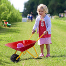 Red children’s wheelbarrow shown during garden play with a styling bucket that is not included