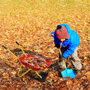Red wheelbarrow staged with autumn leaves and a separate shovel that is not included