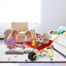 Red children’s wheelbarrow staged indoors with toys that are not included