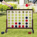 Natural wooden four-in-a-row game with red and blue chips during outdoor play