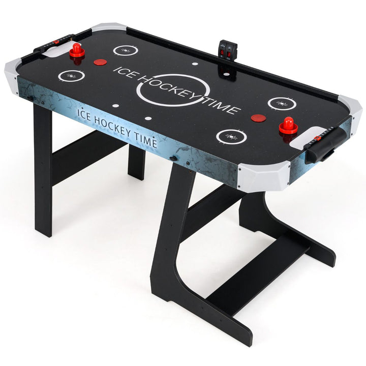 Black folding air hockey table with two red pushers and electronic score display