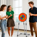 Adults holding toy throwing accessories beside the orange bristle target before play