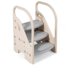 Three-step toddler stool with grey treads, beige side frames and raised handrails