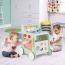 Green play kitchen push walker in a playroom
